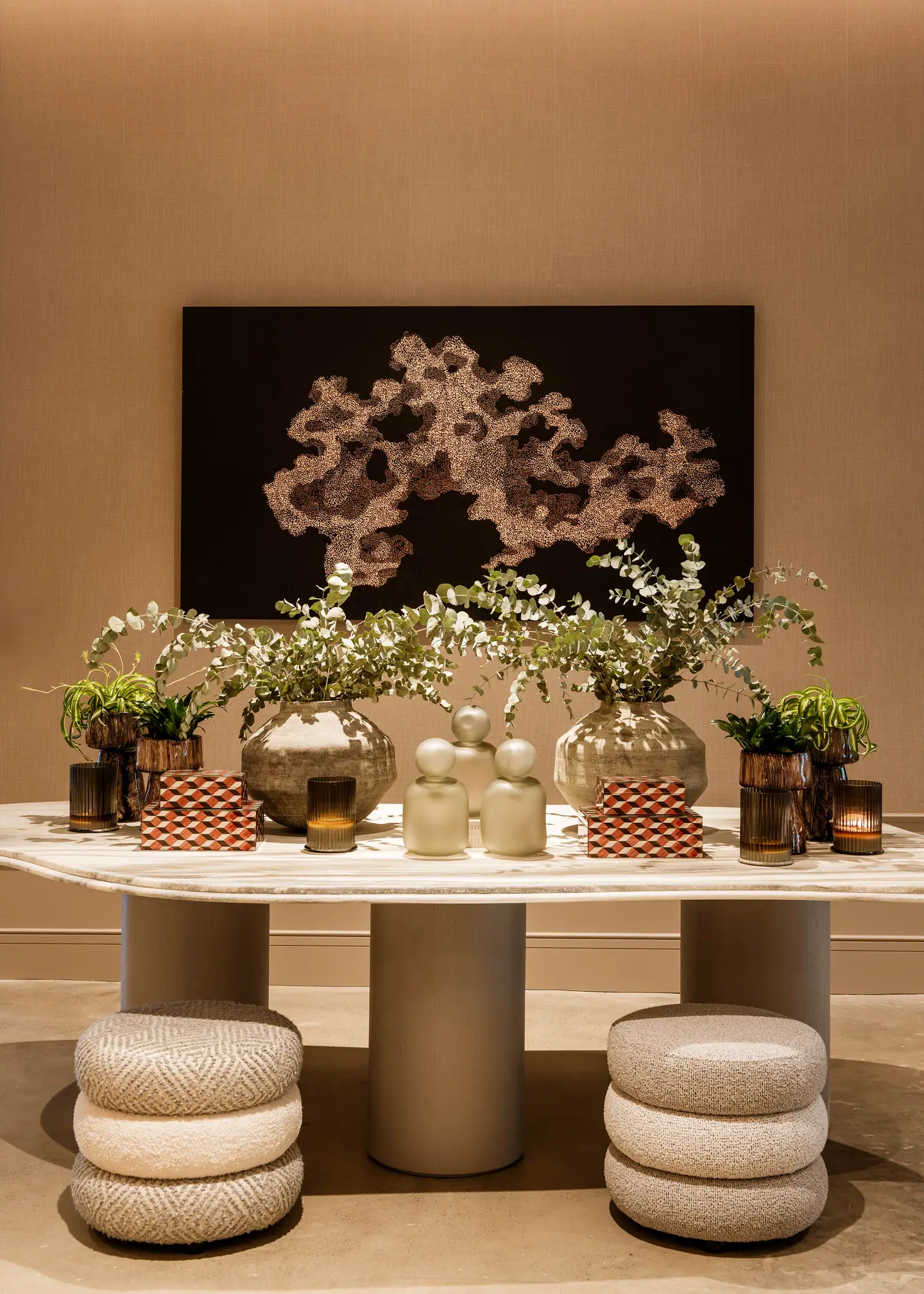 Vases, ceramics and textiles on a travertine console